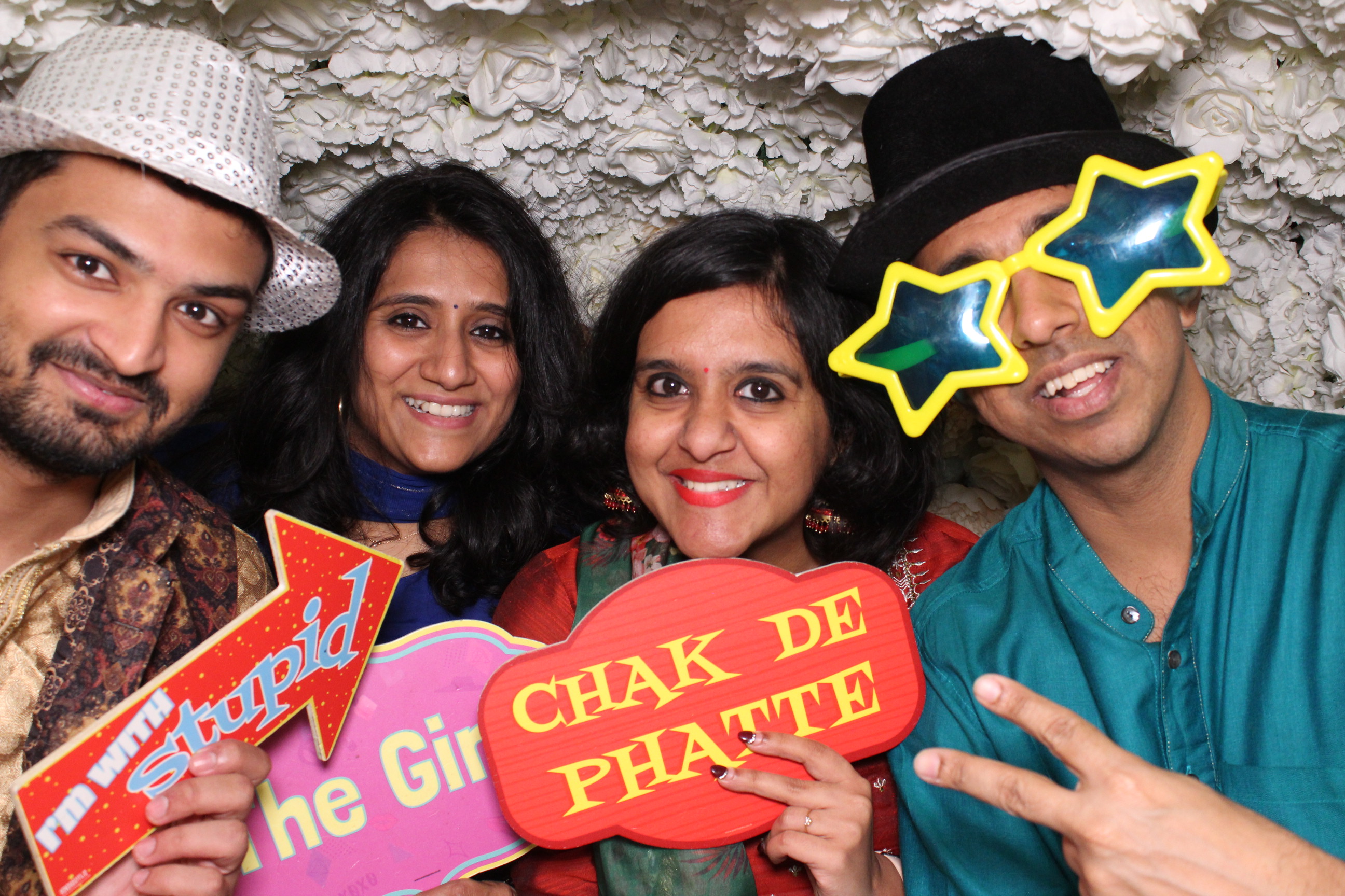 guests enjoying a photobooth experience with party props